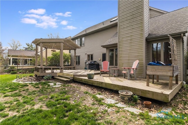 rear view of property with a shingled roof, a pergola, a chimney, and a deck