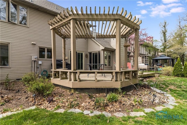 back of property featuring roof with shingles, a pergola, a gazebo, and a deck