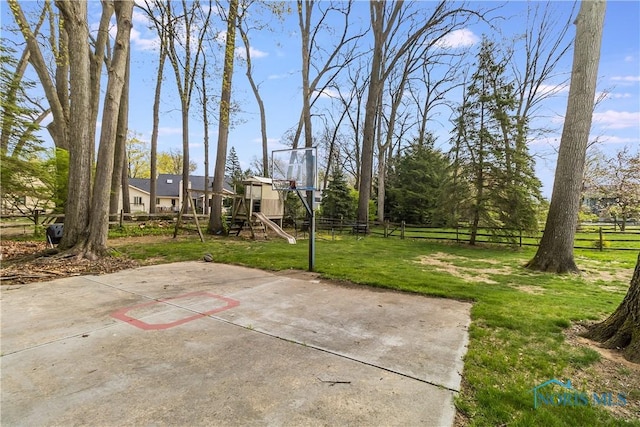 view of patio / terrace with fence and basketball hoop