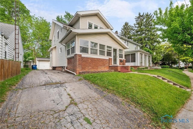 4242 Fairview Dr, Toledo, OH 43612 - view of front of home featuring a sunroom, brick siding, an outbuilding, and a garage