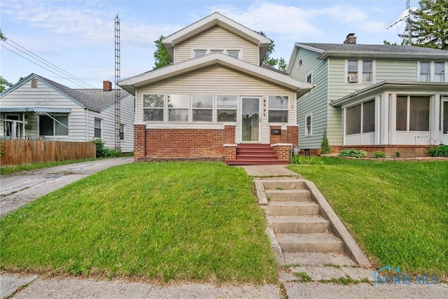 4242 Fairview Dr, Toledo, OH 43612 - view of front of house with entry steps, brick siding, and a sunroom