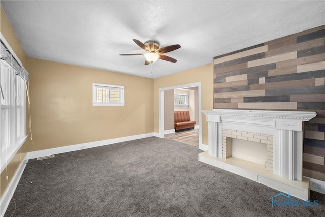 4242 Fairview Dr, Toledo, OH 43612 - unfurnished living room featuring a ceiling fan, carpet floors, baseboards, and healthy amount of natural light