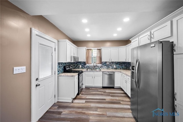 4242 Fairview Dr, Toledo, OH 43612 - kitchen with stainless steel appliances, a sink, light wood-type flooring, recessed lighting, and white cabinets