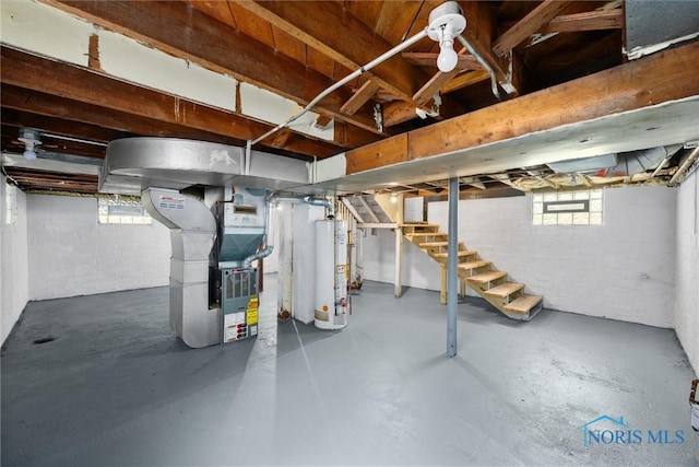 4242 Fairview Dr, Toledo, OH 43612 - below grade area featuring stairs, gas water heater, heating unit, and concrete block wall