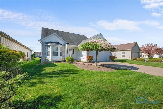 view of front facade with concrete driveway, an attached garage, and a front yard