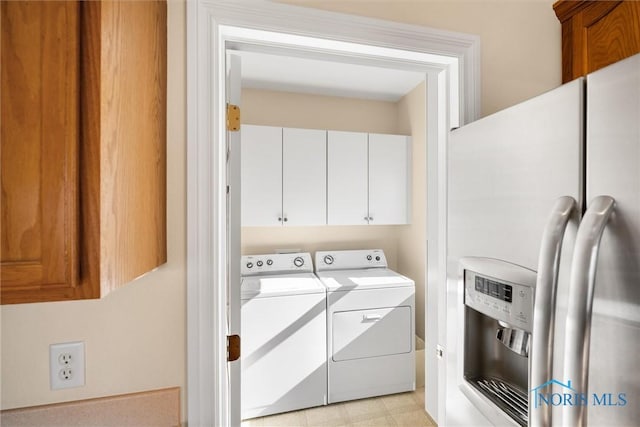 laundry room featuring cabinet space and washer and clothes dryer