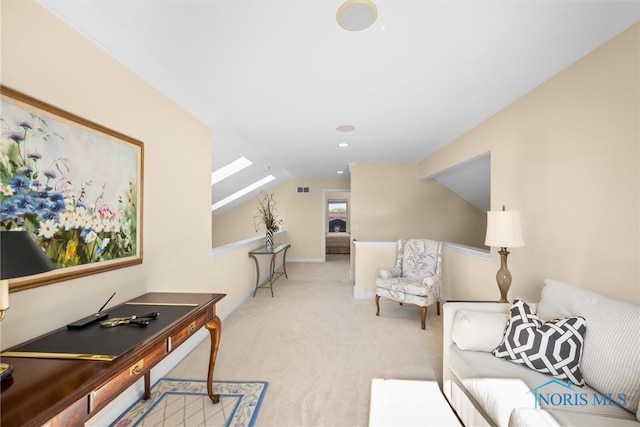 living room with light colored carpet, lofted ceiling with skylight, and visible vents