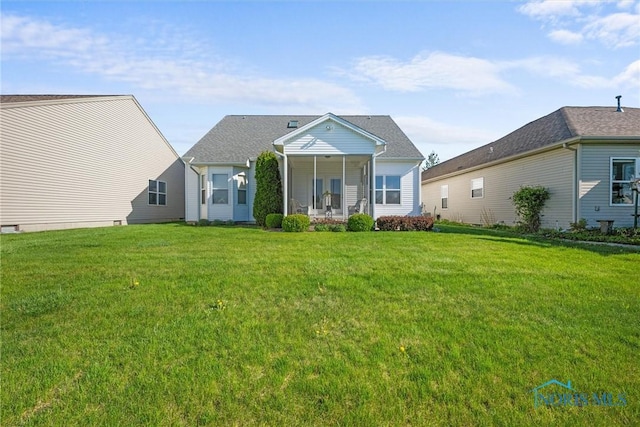 rear view of property with a yard