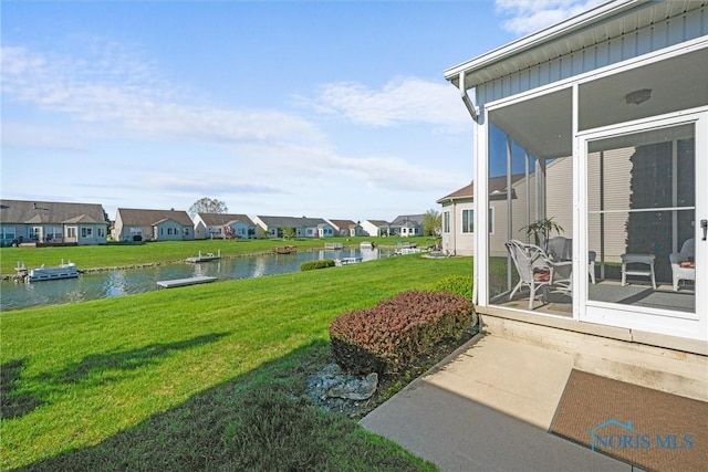 view of yard with a water view and a residential view