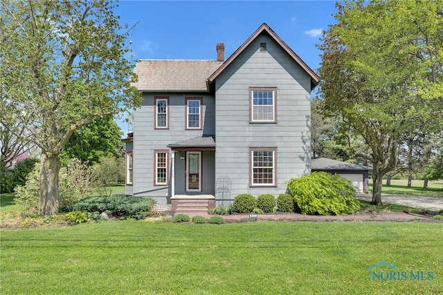 888 Columbus Ave, Fostoria, OH 44830 - traditional home with a chimney and a front lawn