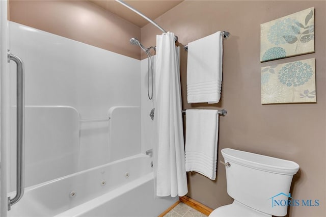 888 Columbus Ave, Fostoria, OH 44830 - bathroom with tile patterned floors, a combined bath / shower with jetted tub, and toilet