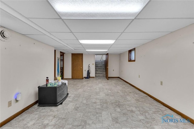 888 Columbus Ave, Fostoria, OH 44830 - finished below grade area with baseboards, a paneled ceiling, and stairway