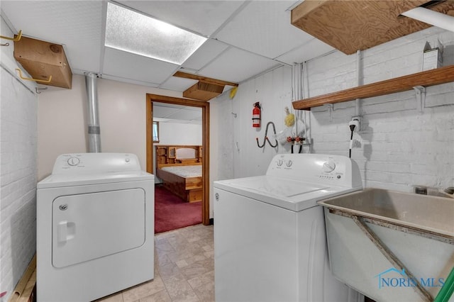 888 Columbus Ave, Fostoria, OH 44830 - laundry room featuring laundry area, a sink, independent washer and dryer, and concrete block wall