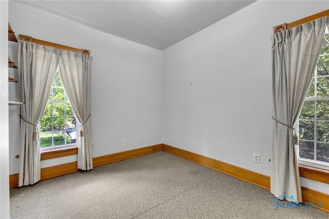 888 Columbus Ave, Fostoria, OH 44830 - carpeted empty room featuring baseboards and a healthy amount of sunlight