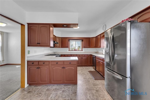 888 Columbus Ave, Fostoria, OH 44830 - kitchen featuring light countertops, appliances with stainless steel finishes, brown cabinets, and a peninsula