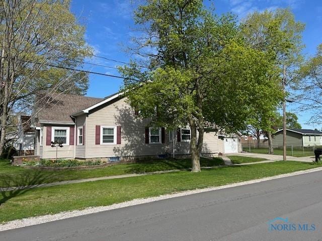 obstructed view of property featuring a front lawn