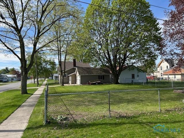 exterior space featuring a yard, fence, and a residential view