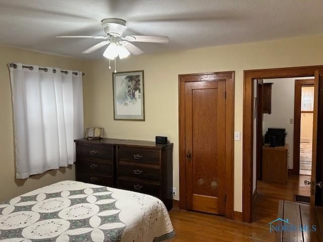 163 E Hull St, Edgerton, OH 43517 - bedroom with wood finished floors and a ceiling fan