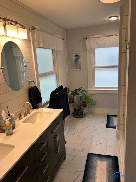 163 E Hull St, Edgerton, OH 43517 - bathroom featuring a sink, double vanity, and marble finish floor