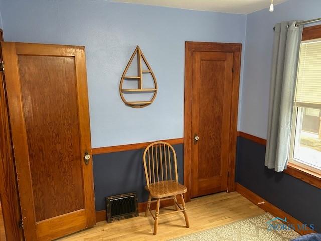163 E Hull St, Edgerton, OH 43517 - living area featuring baseboards, light wood-style flooring, and visible vents