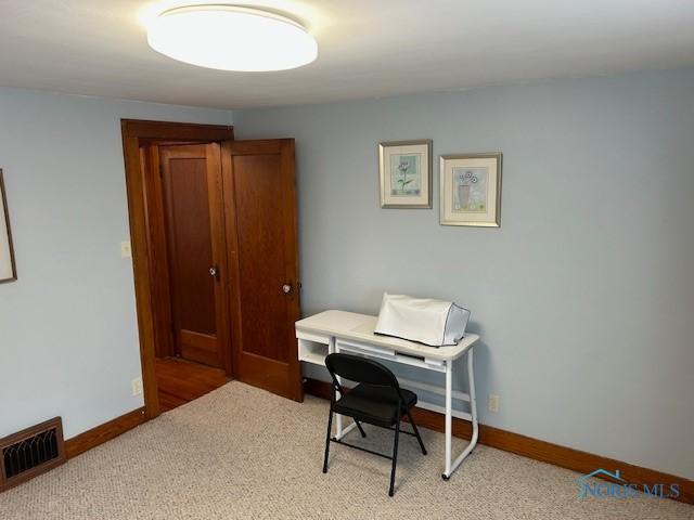 163 E Hull St, Edgerton, OH 43517 - home office featuring baseboards, visible vents, and light colored carpet