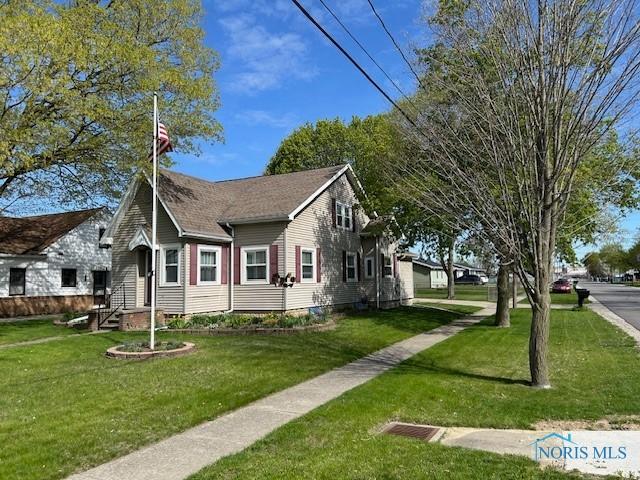 163 E Hull St, Edgerton, OH 43517 - view of home's exterior featuring a yard