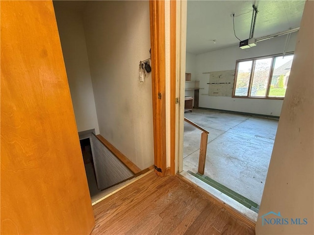interior space with baseboards and wood finished floors