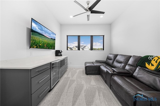living area featuring ceiling fan, light colored carpet, baseboards, beverage cooler, and recessed lighting