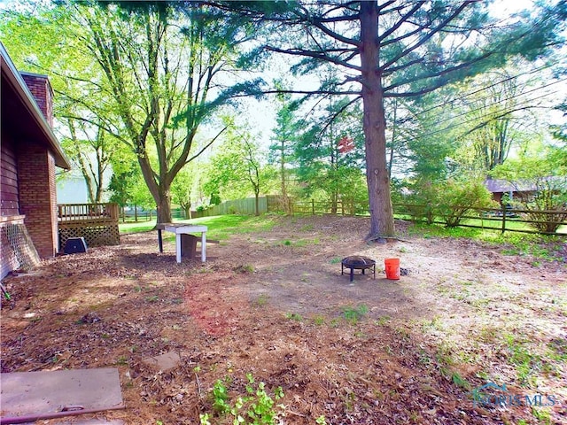 416 Donbar Dr, Bowling Green, OH 43402 - view of yard with a fenced backyard and a wooden deck
