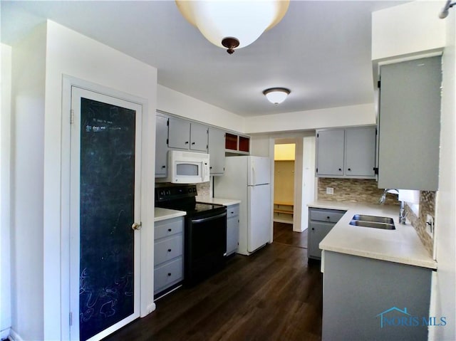 416 Donbar Dr, Bowling Green, OH 43402 - kitchen with gray cabinetry, a sink, decorative backsplash, and white appliances