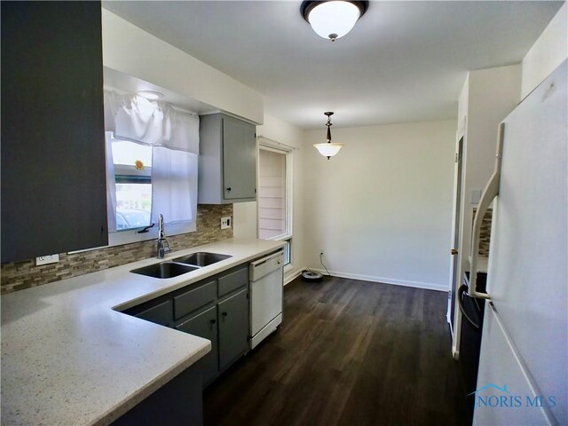 416 Donbar Dr, Bowling Green, OH 43402 - kitchen with dark wood-style flooring, tasteful backsplash, a sink, light countertops, and white appliances