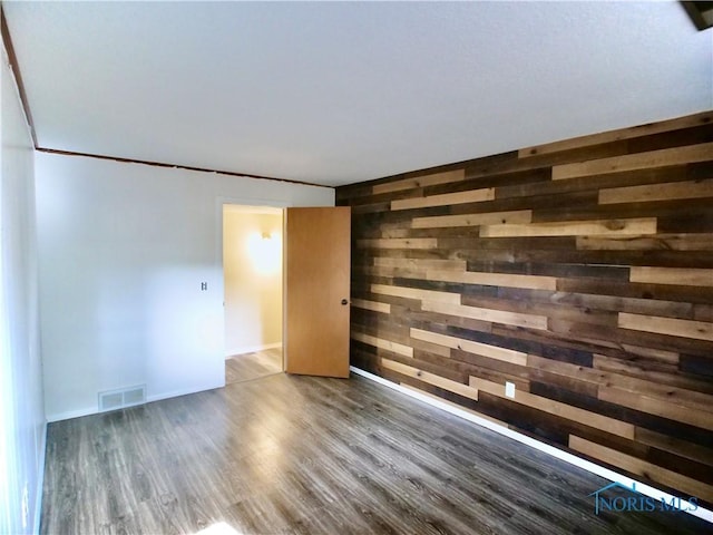416 Donbar Dr, Bowling Green, OH 43402 - spare room with visible vents, wood finished floors, and wooden walls