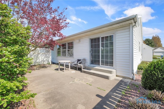 back of house featuring a patio and fence