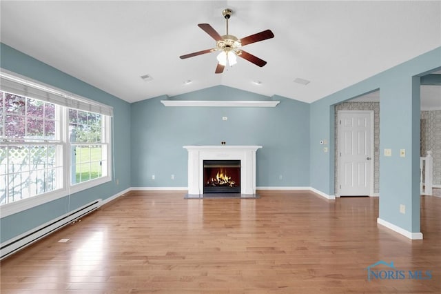 unfurnished living room featuring a ceiling fan, vaulted ceiling, baseboard heating, and wood finished floors