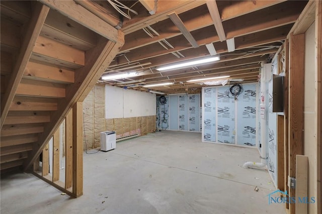 unfinished below grade area featuring stairway