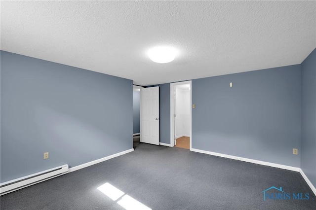 empty room featuring baseboards, a textured ceiling, carpet floors, and a baseboard heating unit