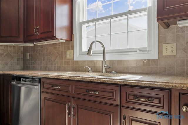 kitchen with a sink, light countertops, tasteful backsplash, and dishwasher