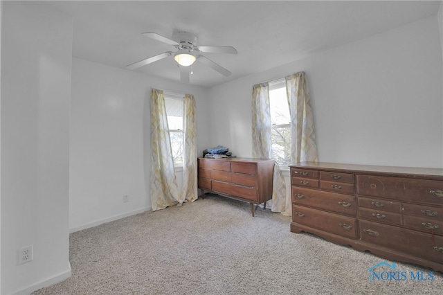 bedroom featuring baseboards, carpet, ceiling fan, and multiple windows
