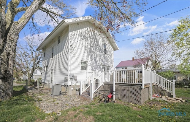 view of home's exterior with stairs, central air condition unit, and a wooden deck