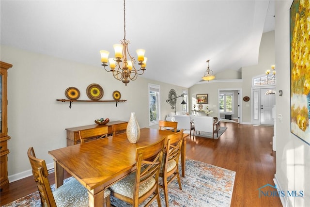 dining area featuring an inviting chandelier, baseboards, and wood finished floors
