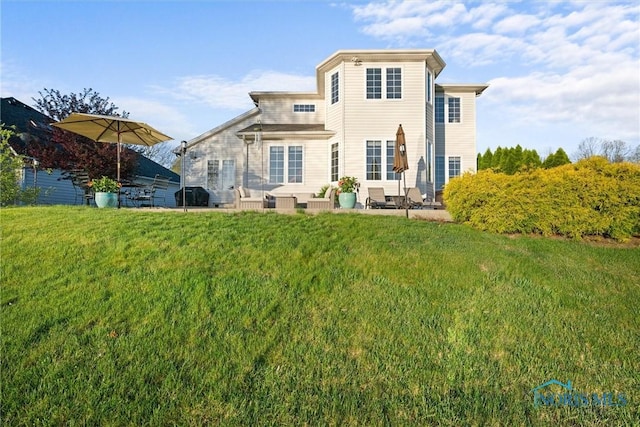 back of house with a lawn and a patio area