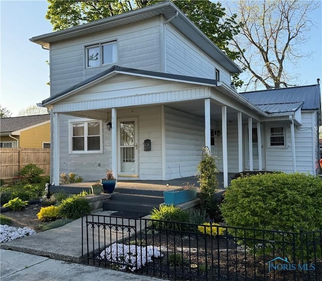 view of front of home featuring covered porch and a fenced front yard