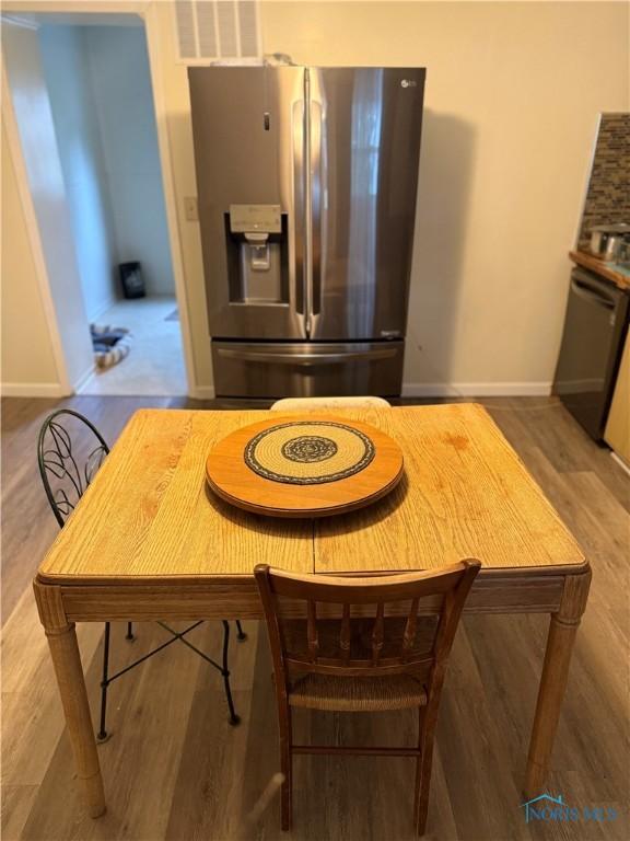 444 Rector Ave, Findlay, OH 45840 - kitchen featuring stainless steel fridge with ice dispenser, dishwasher, baseboards, and wood finished floors