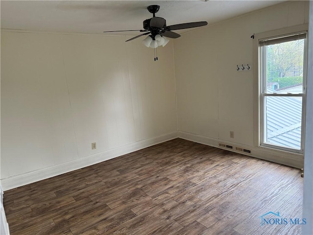 444 Rector Ave, Findlay, OH 45840 - spare room featuring dark wood-style flooring, plenty of natural light, a ceiling fan, and baseboards