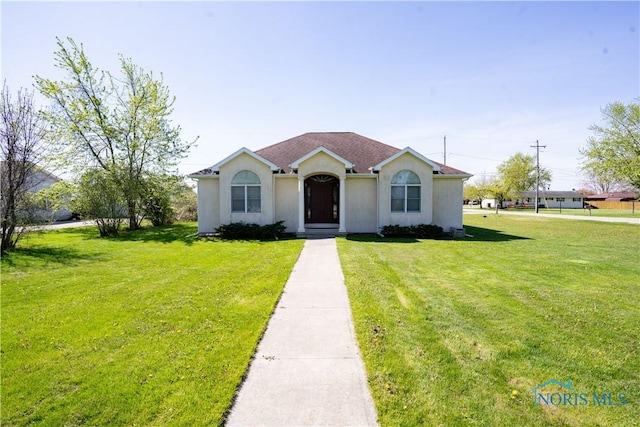 bungalow-style home featuring a front lawn and stucco siding
