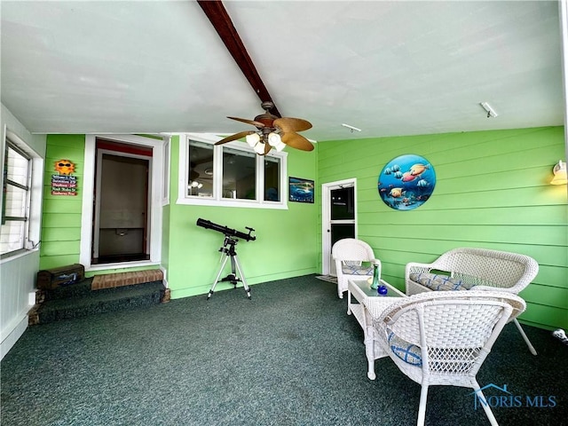 sunroom featuring ceiling fan