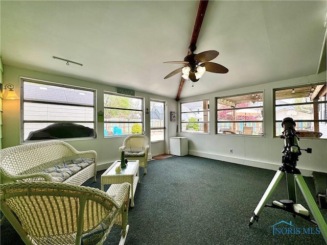sunroom featuring plenty of natural light and beam ceiling