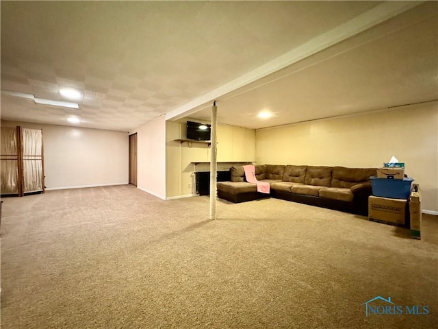 carpeted living area featuring baseboards