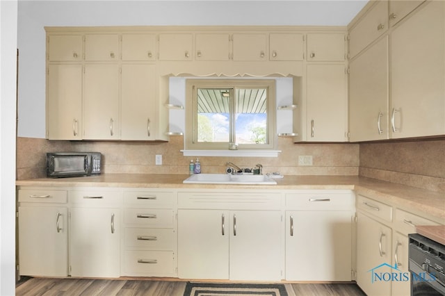 kitchen featuring a sink, tasteful backsplash, and light countertops