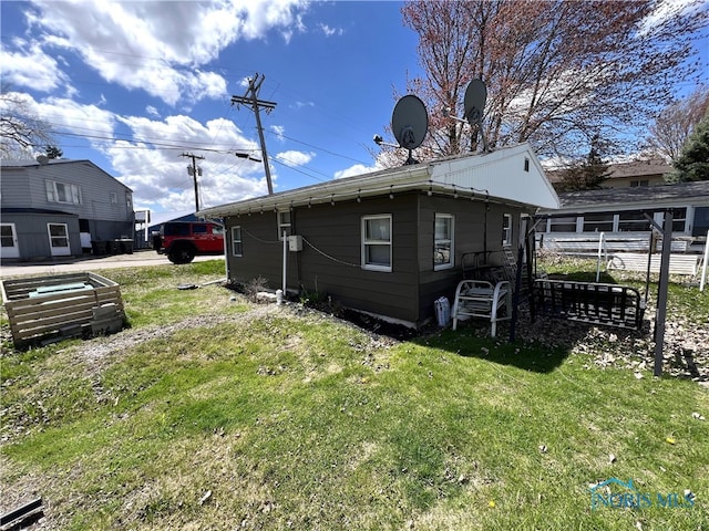 view of property exterior with a yard